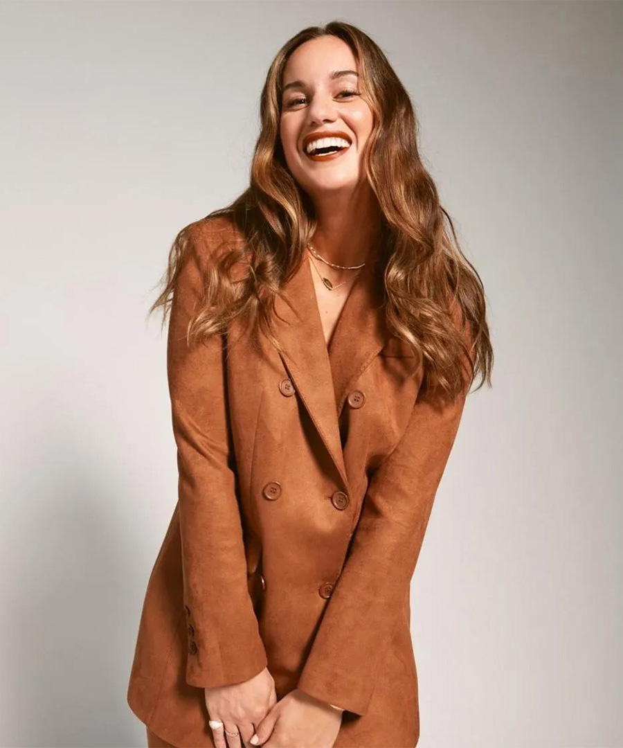 Hannah Berner smiling in brown coat.
