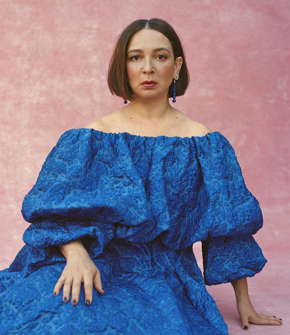 Maya Rudolph in fluffy, vibrant blue gown, leaning on one hand.